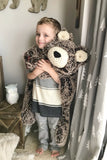Child holding a large plush bear rug made by ClaraLoo in a woodland themed bedroom.
