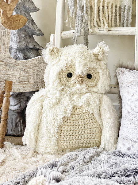 A white owl stuffed animal made by ClaraLoo with crocheted accents.