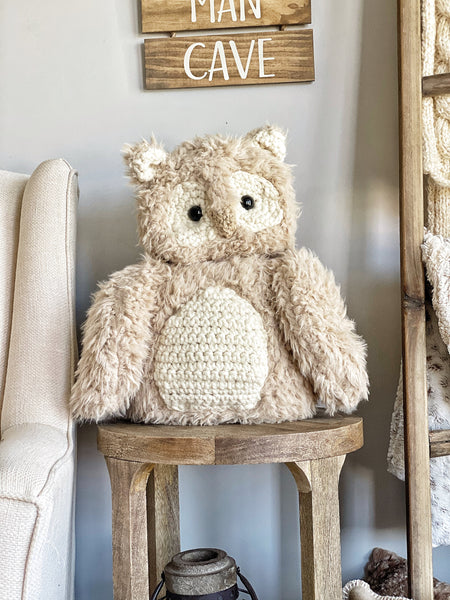 A beige plush owl handmade by ClaraLoo with cream colored crochet accents.