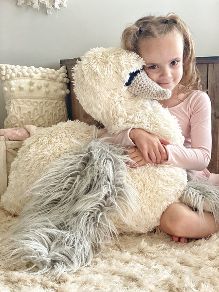 A plush swan stuffed animal with soft white and silver fabric.