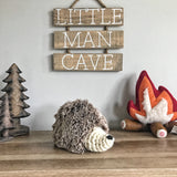 A plush hedgehog handmade by ClaraLoo with soft brown faux fur and a cream colored crocheted face.
